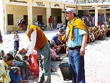 Party workers serve water to voters