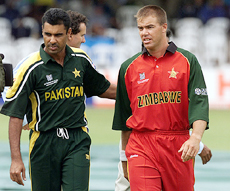 Zimbabwe captain Heath Streak leaves the pitch with Pakistan skipper Waqar Younis after the two agreed to abandon the final Group-A qualifier of the cricket World Cup