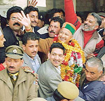 A garlanded Virbhadra Singh is surrounded by his supporters after being elected leader of the Congress Legislature Party of Himachal Pradesh