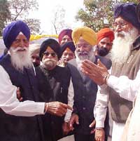 SAD President Parkash Singh Badal and General Secretary Sukhdev Singh Dhindsa exchange greetings with Gurcharan Singh Tohra at his residence 