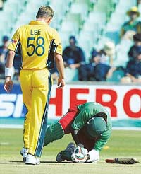 Australias Brett Lee walks towards Kenyas Kennedy Obuya after Obuya was hit by a ball bowled by Lee during their World Cup Super Six match at Kingsmead cricket ground in Durban, South Africa, on Saturday. 
