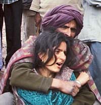 Wailing family members of a policeman killed in a terrorist attack on a police post in Gool, Udhampur