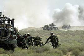 Marines of the US Marine Expeditionary Unit Fox Company "Raiders" take cover from Iraqi fire