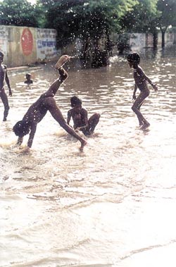 Children enjoy in rainwater