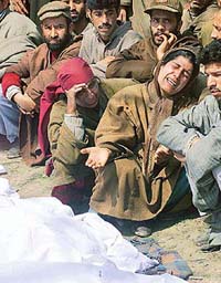 Muslim women villagers wail near the shroud-covered bodies of Kashmiri Pandits at Nadimarg village