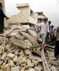 An Iraqi girl walks through the rubble of a building, on Tuesday, which Iraqi authorities say was destroyed during an air strike in Baghdad. 