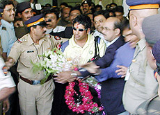 Star batsman Sachin Tendulkar is surrounded by security personnel and fans on arrival in Mumbai