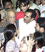 The grieving father and other family members of former Home Minister