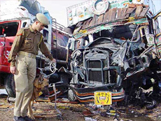 A policeman inspects the wreckage of an oil tanker