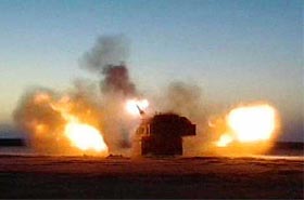 In this image from video, a US Army Paladin artillery vehicle fires during a firefight with Iraqi forces