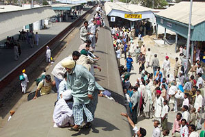 Commuters travel on the roof of a Sirsa-bound overcrowded train