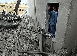 An Iraqi worker gestures inside a destroyed communication centre in Baghdad on Sunday