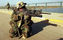Soldiers of the 15th Marine Expeditionary Unit (MEU) Fox Company Raiders secure a bridge 