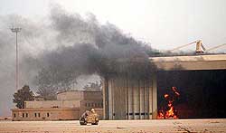 A fuel tank burns in a hangar at Saddam International Airport, near Baghdad