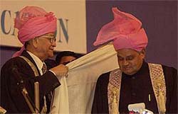 The Chancellor of Kashmir University, Mr G.C. Saxena, drapes the ceremonial shawl around Prime Minister Atal Behari Vajpayees shoulders