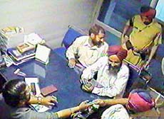 A photograph from the video-cassette showing money changing hands