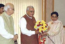 Prime Minister Atal Behari Vajpayee is presented with a bouquet by UP Chief Minister Mayawati in New Delhi on Sunday 
