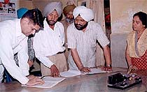 Vigilance sleuths, led by the DSP, Mr Rashpal Singh, check the register at the Primary Health Centre