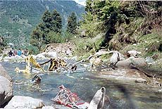 Wreckage of the VT-HIM helicopter lies scattered in the Alani nullah