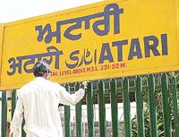 The boundary grill at the Attari railway station gets a fresh coat of paint in Amritsar on Tuesday.