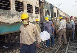 Rescue workers carry the body of a victim