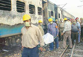 Rescue workers carry the body of a victim from the Amritsar-bound Golden Temple Express, which caught fire near Laddowal railway station, 10 km from Ludhiana, on Thursday.