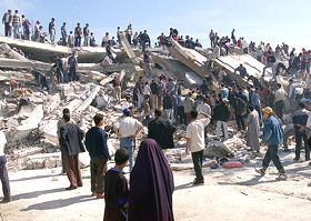 Inhabitants of the Algerian town of Boumerdes watch as rescue workers sift through the debris of a large apartment building, which comprised 78 flats, on Thursday.