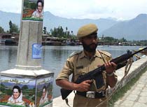 A jawan stands guard near Dal Lake