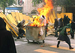 Anti-G8 demonstrators block a street with a burning container in downtown Lausanne during a protest march in the Swiss city across Lake Geneva from Evian, site of the G-8 summit.