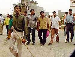 Dalit youth armed with lathis move towards the national highway at Phagwara on Monday.