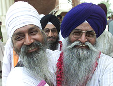 A Pakistan Sikh (left) greets Indian pilgrims at the Wagah border check-post, as they cross into Pakistan on Saturday.