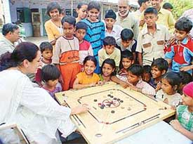 Ms Madhavi Kataria of the UT Red Cross enjoys a game of carom with children of the Sector 30 labour colony where she gifted an infrastructure for three games