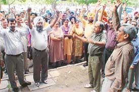 Members of the Punjab State Cooperative Agriculture Development Bank protest in support of their demands in Sector 17