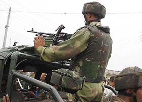 Army personnel patrol the Army camp at Sanjawan near Jammu