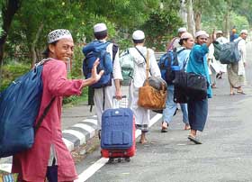 Malaysian delegation wave to Indians before crossing the Wagha check post on Saturday