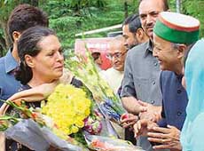 Himachal Chief Minister Virbhadra Singh presents a bouquet to Mrs Sonia Gandhi on her arrival at Shimla on Sunday. 