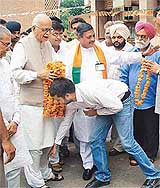A BJP worker touches the feet of Deputy Prime Minister L.K. Advani