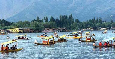Tourists enjoy Shikara ride in Kashmirs Dal Lake in Srinagar on Friday.