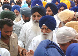 The President of the Shiromani Akali Dal, Mr Parkash Singh Badal, escorts Mr Gurcharan Singh Tohra to the SGPC office in Amritsar before his formal appointment as 26th president of the committee on Sunday.