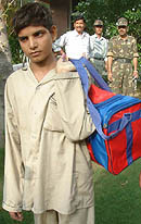 Pakistani boy Munir crosses over to his country from the Wagah checkpost in Amritsar on Tuesday.
