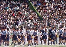 Kashmiris occupy every vantage point at the Bakshi Stadium to watch a marchpast by schoolchildren during the Independence Day celebrations in Srinagar