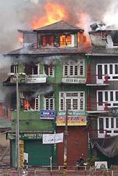 Flames and smoke billow out from a hotel building
