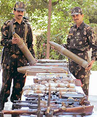 Army personnel display arms and ammunition seized from five militants killed in an encounter near the LoC in the Tangdhar sector of Kupwara district on Monday.