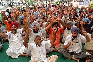 Members of Punjab State Ministerial Staff Union raise slogans at a dharna in front of the district administrative complex in Bhatinda