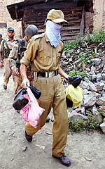 A BSF jawan carries polythene bags containing explosives