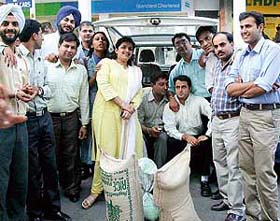 Employees of Standard Chartered Bank, Sector 9, with the rations presented to Sri Guru Granth Sahib Seva Society, Chandigarh