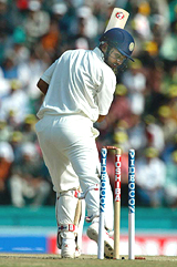 Virender Sehwag looks back after being bowled by New Zealand bowler Scott Styris 