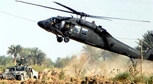 A US Army Blackhawk helicopter lifts off as troops search the site where a Chinook helicopter crashed into a field near the restive town of Palluja on Sunday.
