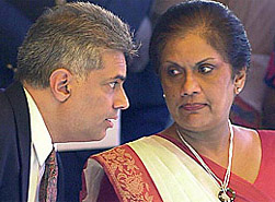 Sri Lankan President Chandrika Kumaratunga and Prime Minister Ranil Wickremesinghe, long-time political rivals, chat during a ceremony to mark Sri Lankas 54th independence day celebrations in Colombo in this file photo taken on February 4, 2002