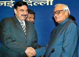 Prime Minister Atal Behari Vajpayee (R) shakes hand with Pakistani Information Minister Sheikh Rashid Ahmed during the SAARC Information Ministers' meeting in New Delhi on Tuesday